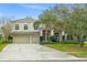 Traditional two-story home with a three-car garage, manicured landscaping, and a welcoming front entrance at 10361 Mallard Landings Way, Orlando, FL 32832