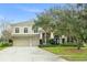 Stunning two-story home with mature landscaping and a three-car garage at 10361 Mallard Landings Way, Orlando, FL 32832