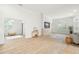 Bright living room with wood floors, plantation shutters, textured stone accent wall, and seamless flow for entertaining at 10361 Mallard Landings Way, Orlando, FL 32832