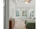 Main bedroom with decorative tray ceiling, ample light, and wood floors at 10361 Mallard Landings Way, Orlando, FL 32832