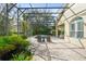 Screened-in pool area with brick pavers, pond, lounge chairs, and lush landscaping creates a tranquil outdoor retreat at 10361 Mallard Landings Way, Orlando, FL 32832