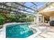 An inviting pool and hot tub are surrounded by brick pavers and a screened enclosure for outdoor enjoyment at 10361 Mallard Landings Way, Orlando, FL 32832