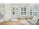 Bright sitting area with modern arched windows, light wood floors, and neutral decor at 10361 Mallard Landings Way, Orlando, FL 32832