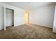 Spacious carpeted bedroom features a closet and white walls at 10840 Cabbage Tree Loop, Orlando, FL 32825