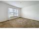 Bright carpeted bedroom with a large window providing natural light at 10840 Cabbage Tree Loop, Orlando, FL 32825