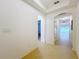 Bright hallway featuring neutral tiling and arched doorways leading to other rooms at 10840 Cabbage Tree Loop, Orlando, FL 32825