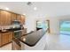 Kitchen with stainless steel appliances and a view of the breakfast bar and backyard at 10840 Cabbage Tree Loop, Orlando, FL 32825