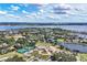 Community aerial view with clubhouse, pool, tennis courts, lakes, and lush landscaping at 11237 Camden Park Dr, Windermere, FL 34786