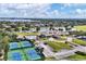 An aerial view of the community clubhouse, pool, tennis courts, and lake at 11237 Camden Park Dr, Windermere, FL 34786