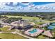 Aerial view of the community clubhouse and golf course with lush landscaping at 11237 Camden Park Dr, Windermere, FL 34786