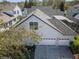 An aerial view of the home with the four-car garage, adjacent to a screened-in pool, from above at 11237 Camden Park Dr, Windermere, FL 34786