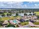 Community clubhouse and pool area, with a view of a lake surrounded by a golf course and landscaping at 11237 Camden Park Dr, Windermere, FL 34786