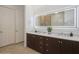 Modern bathroom featuring a double vanity with an illuminated mirror and sleek fixtures at 11237 Camden Park Dr, Windermere, FL 34786