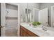 This bathroom features double sinks with modern faucets, white tile backsplash, and a shower and tub combo at 11237 Camden Park Dr, Windermere, FL 34786