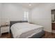 A serene bedroom featuring a large bed with white linens, wood floors, and bedside tables with lamps at 11237 Camden Park Dr, Windermere, FL 34786