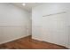 Neutral bedroom includes hardwood floors, white walls, and a closet for storage at 11237 Camden Park Dr, Windermere, FL 34786