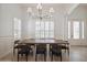 Dining room featuring modern lighting, wainscoting and large wooden table and chairs at 11237 Camden Park Dr, Windermere, FL 34786