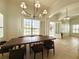 Bright dining area with a large window, shutter blinds, a modern chandelier, and access to the front porch at 11237 Camden Park Dr, Windermere, FL 34786