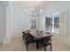 Elegant dining room with a large window, modern chandelier, and seating for eight, perfect for entertaining at 11237 Camden Park Dr, Windermere, FL 34786