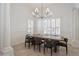 Elegant dining room with a modern chandelier, plantation shutters, and tiled flooring at 11237 Camden Park Dr, Windermere, FL 34786