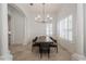 Dining room showcasing a modern chandelier, window shutters and a large wooden table at 11237 Camden Park Dr, Windermere, FL 34786