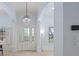 Bright and airy foyer with a decorative chandelier, tile floors, and leaded glass door at 11237 Camden Park Dr, Windermere, FL 34786