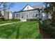 Charming home with a meticulously landscaped front yard, elegant columns, and a welcoming porch at 11237 Camden Park Dr, Windermere, FL 34786