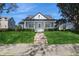 Charming home with a meticulously landscaped front yard, elegant columns, and a welcoming porch at 11237 Camden Park Dr, Windermere, FL 34786