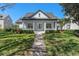 Charming home with a welcoming front porch, manicured lawn, and beautiful landscaping for curb appeal at 11237 Camden Park Dr, Windermere, FL 34786