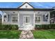 Charming home featuring a covered porch with white columns and a well-maintained front lawn at 11237 Camden Park Dr, Windermere, FL 34786