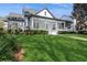 This home features a lush green lawn, a covered front porch, and fresh landscaping, creating a welcoming exterior at 11237 Camden Park Dr, Windermere, FL 34786