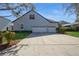 Home's exterior featuring a three-car garage, well-manicured landscaping, and a spacious driveway at 11237 Camden Park Dr, Windermere, FL 34786