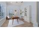 Bright home office featuring built-in shelving, a modern desk, and abundant natural light at 11237 Camden Park Dr, Windermere, FL 34786