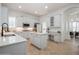 White kitchen with center island, stainless steel appliances, and adjacent dining area at 11237 Camden Park Dr, Windermere, FL 34786