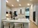 Well-lit white kitchen with quartz counters, bar seating, and stainless appliances at 11237 Camden Park Dr, Windermere, FL 34786