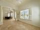 Spacious living room featuring large windows, tile floors, and elegant architectural details at 11237 Camden Park Dr, Windermere, FL 34786