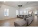 Spacious living room featuring a large sofa and neutral tile floors at 11237 Camden Park Dr, Windermere, FL 34786