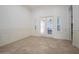 Living room featuring neutral tile floors, white trim and large glass doors at 11237 Camden Park Dr, Windermere, FL 34786