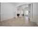 Elegant living room featuring large archways, white trim and neutral tile floors at 11237 Camden Park Dr, Windermere, FL 34786