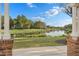 Scenic pond view from a covered area with lush greenery and mature trees at 11237 Camden Park Dr, Windermere, FL 34786