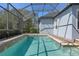 Inviting screened-in pool with clear blue water, paver decking, and lush landscaping at 11237 Camden Park Dr, Windermere, FL 34786