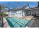 Large screened-in pool with a paver deck and surrounding hedges for privacy at 11237 Camden Park Dr, Windermere, FL 34786