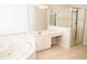 Bathroom with double vanity, soaking tub, and glass-enclosed shower at 11474 Claymont Cir, Windermere, FL 34786