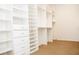 Spacious walk-in closet with custom white shelving and drawers for optimal storage at 11474 Claymont Cir, Windermere, FL 34786