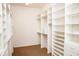 Bright walk-in closet featuring custom white shelving and drawers, offering ample storage at 11474 Claymont Cir, Windermere, FL 34786
