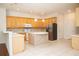 Bright kitchen featuring stainless steel appliances, tile flooring, and island with seating at 11474 Claymont Cir, Windermere, FL 34786