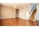 Living room with wood flooring, staircase, built-in shelving, and ceiling fan at 11474 Claymont Cir, Windermere, FL 34786