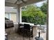 A covered outdoor kitchen and entertainment area with bar seating at 11474 Claymont Cir, Windermere, FL 34786