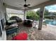 A covered outdoor kitchen and entertainment area at 11474 Claymont Cir, Windermere, FL 34786