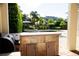 Outdoor kitchen overlooks the pool and lush landscaping, creating a private backyard oasis at 11474 Claymont Cir, Windermere, FL 34786